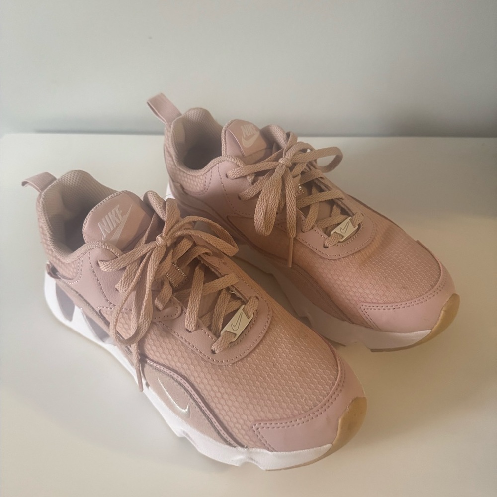 Women’s pink and white Nike shoes
